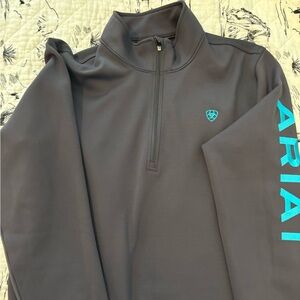 Grey XXL Ariate lightweight jacket with teal writing.